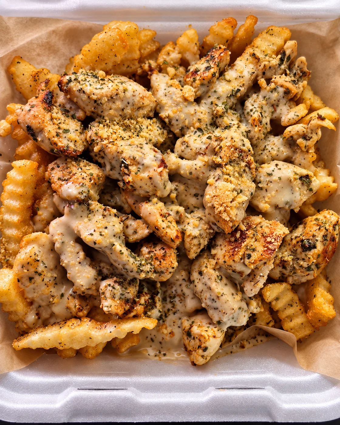 The Chatham loaded fries with grilled chicken, Alfredo sauce and seasoning