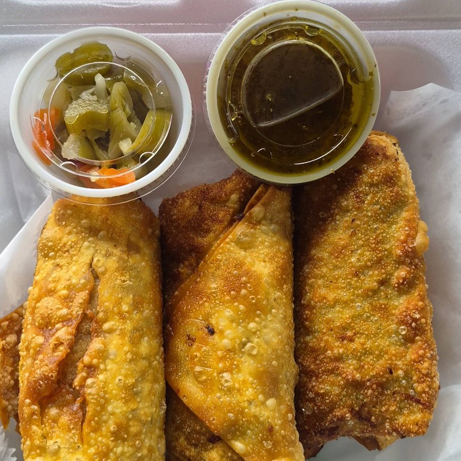 Chi Spot egg rolls boxed with giardiniera and dipping sauce, packed for delivery